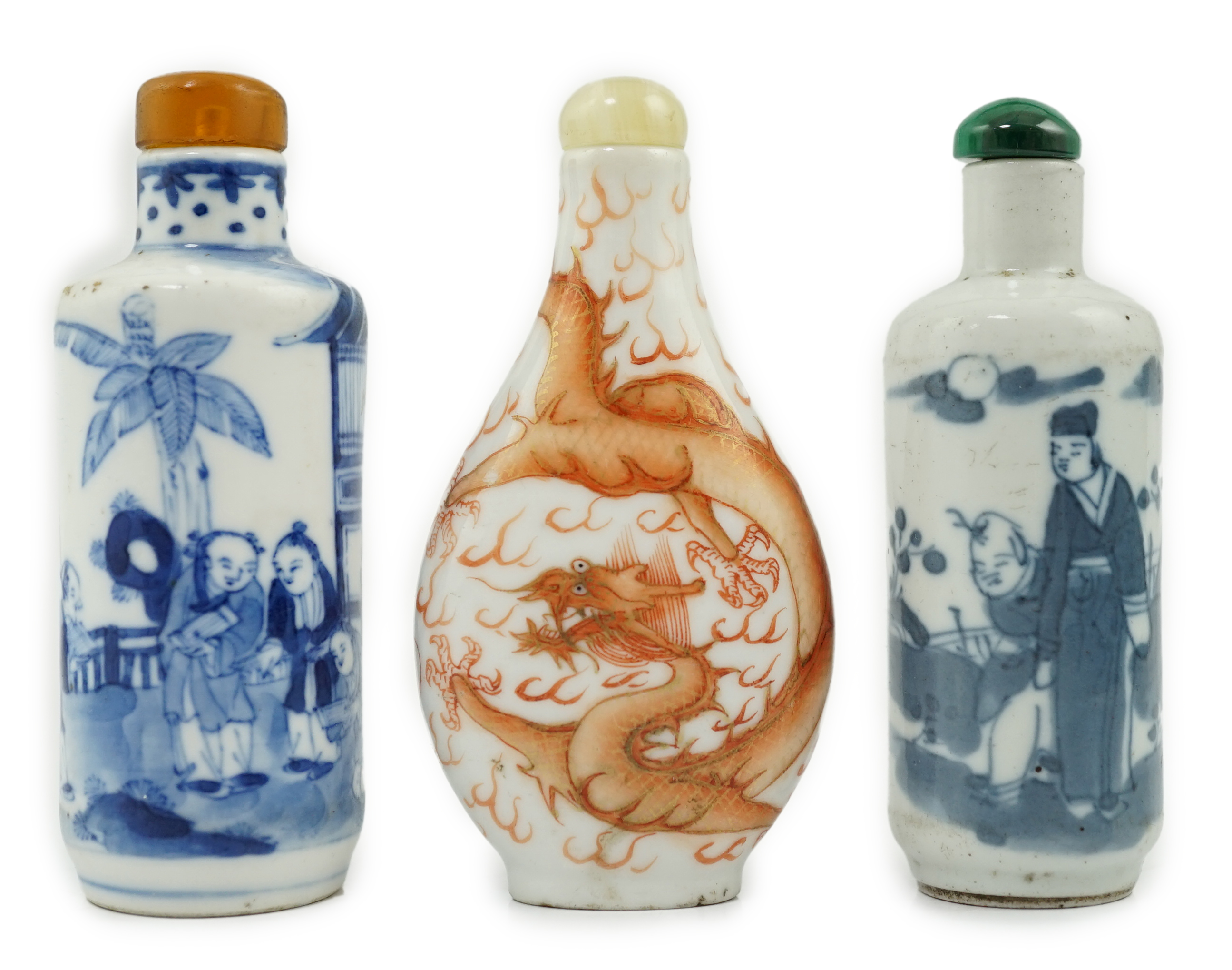 A Chinese iron red enamelled ‘dragon’ snuff bottle, Tongzhi mark and of the period (1862-74), together with two Chinese blue and white cylindrical snuff bottles, 19th century